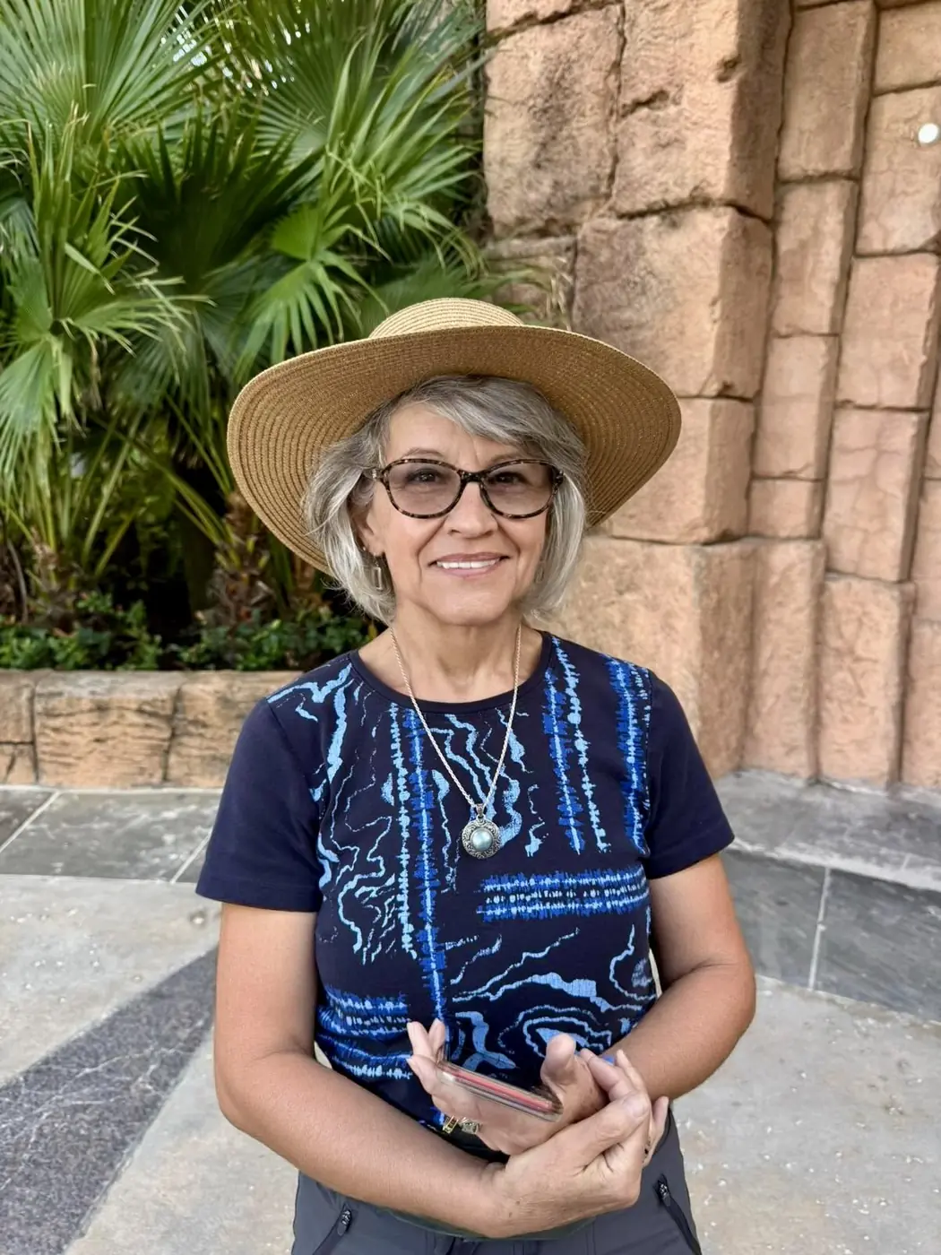 Yvette in a sunhat and sunglasses on a sunny travel day